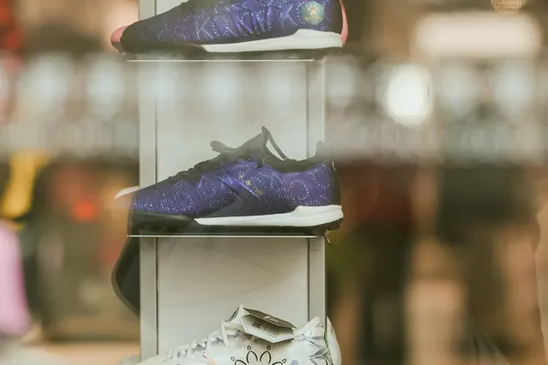 Sneaker collection displayed on shelf