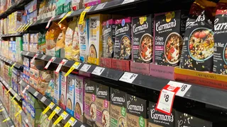 Retail store entrance with signs promoting special discount programs