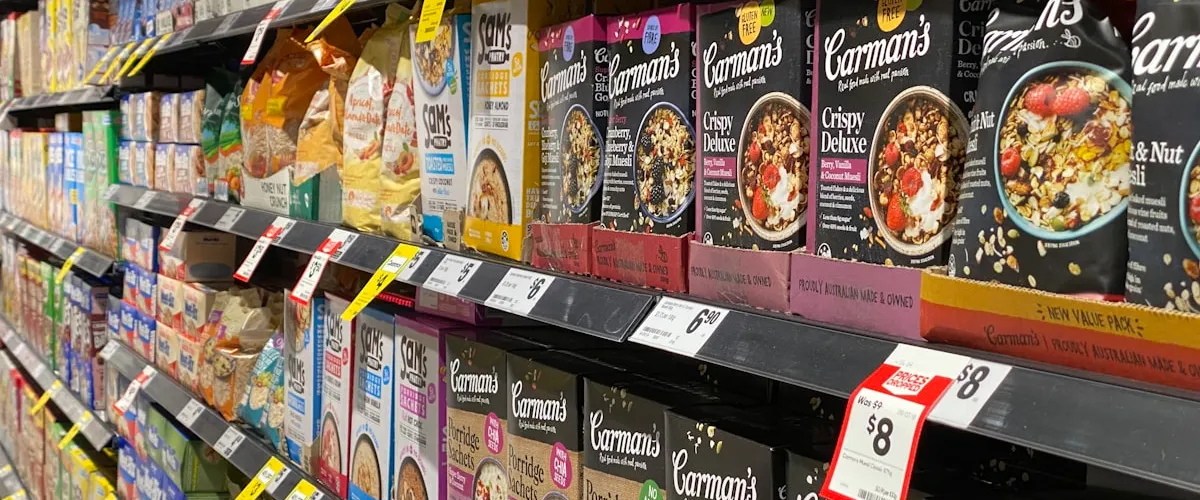 Retail store entrance with signs promoting special discount programs